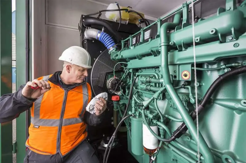 Mechanic checking the generator's technical condition Mechanic checking the generator's technical condition